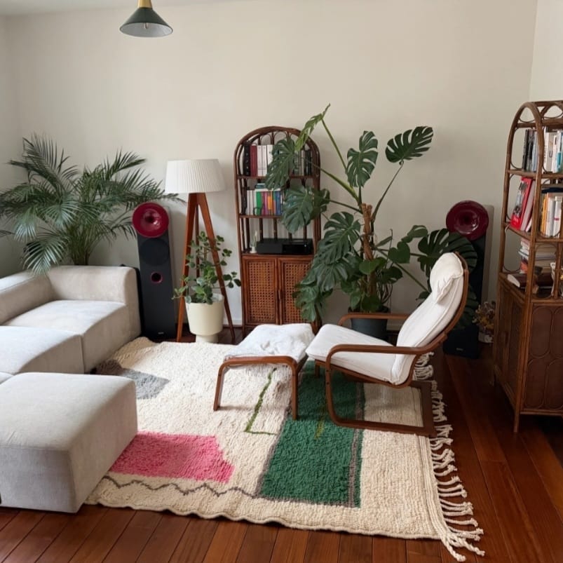 Cozy living room styled with a handmade Moroccan Boujad wool rug in cream, pink, and green