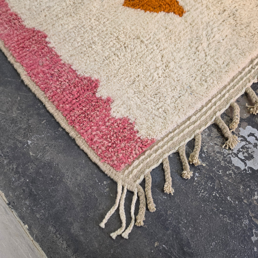 Pink corner of the abstract Azilal rug with hand-tied fringe
