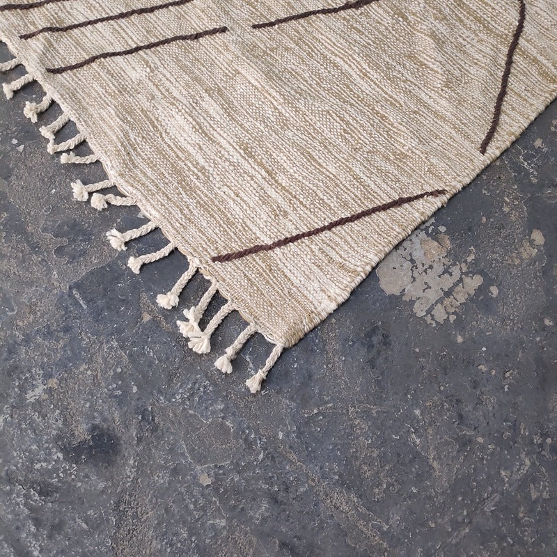 Close-up of Moroccan Kilim rug corner showing fringe and flat-woven wool texture