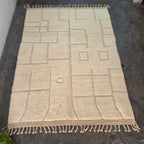 Solid ivory Beni Ourain rug laid flat, full top-down view of the carved square pattern
