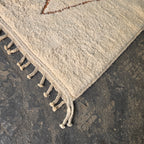 Close-up of hand-knotted fringe tassels on a Moroccan Berber wool rug