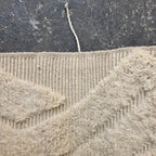 Close-up of the woven reverse side and pile edge of the oversized Beni Ourain rug