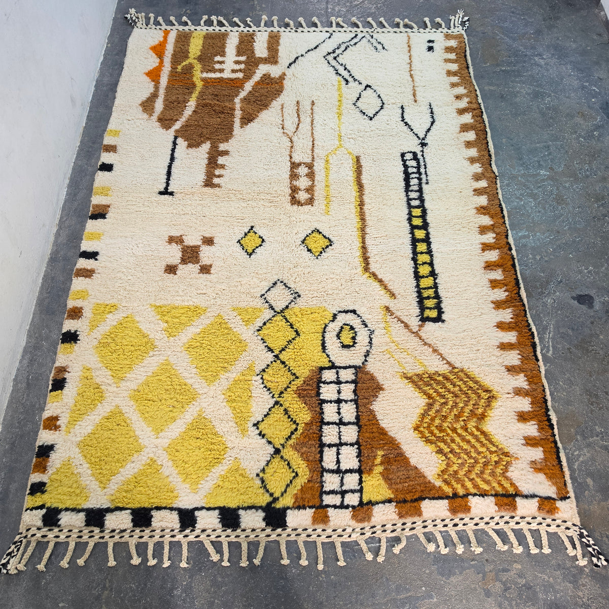Authentic Moroccan Berber rug laid flat, full top-down view of ivory wool with tribal pattern