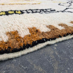 Close-up of brown and rust wool pile texture on a Moroccan Berber rug corner
