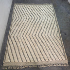 Moroccan Beni Ourain rug laid flat, full top-down view of wavy chevron pattern in ivory wool