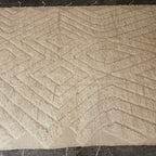 Top view of the carved diamond and X relief pattern on the oversized Beni Ourain rug