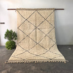 Authentic Beni Ourain rug hanging on display, ivory wool with black diamond lattice