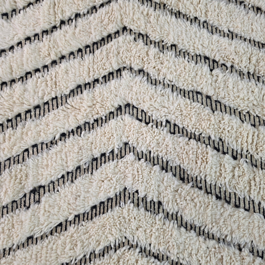 Macro close-up of wavy chevron zigzag pattern woven into ivory wool
