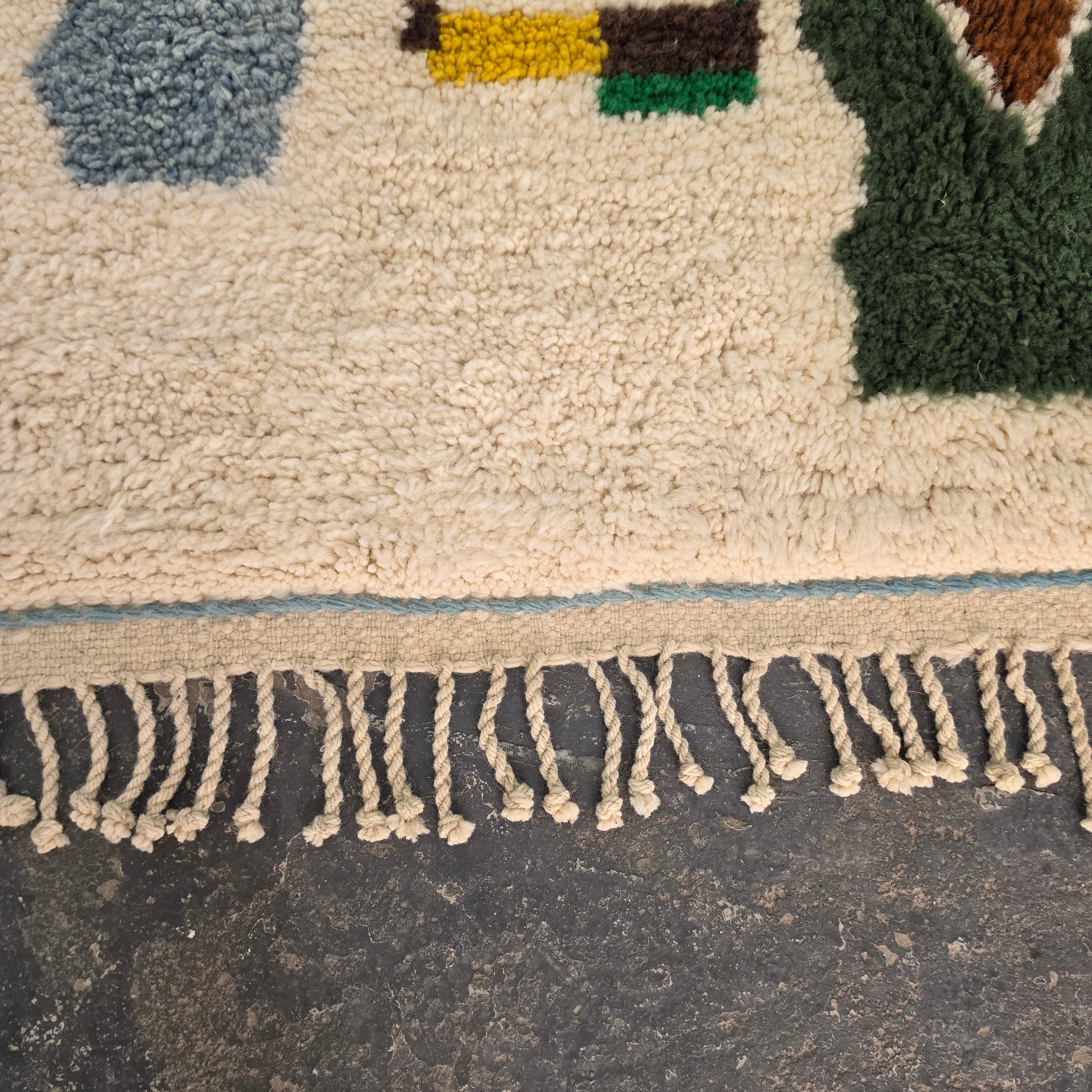 Close-up of hand-tied fringe tassels on a Moroccan Boujad wool rug