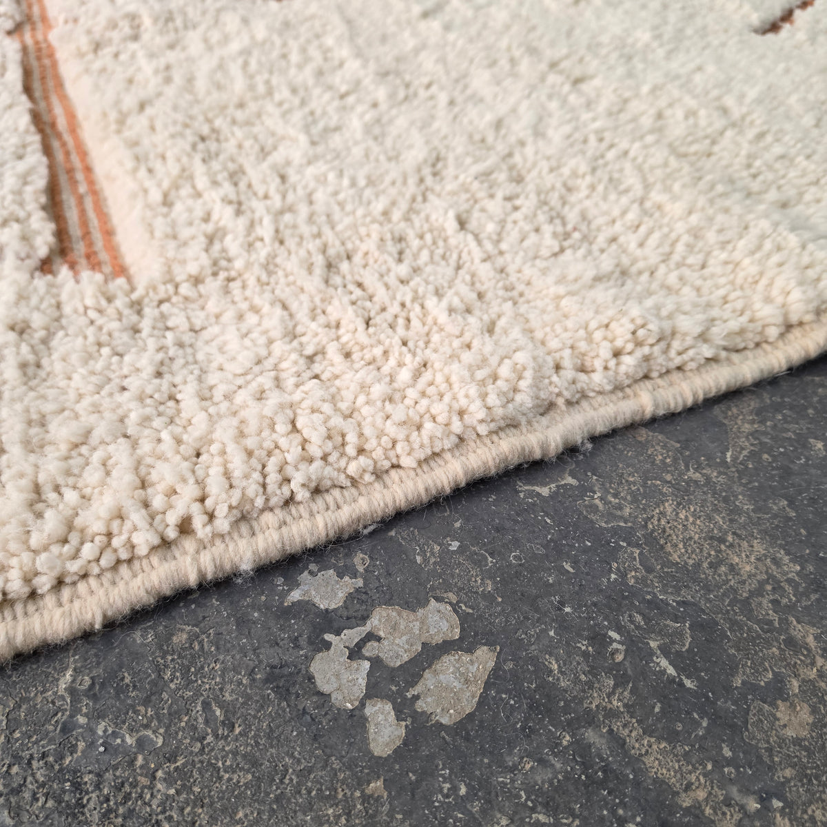 Close-up of thick cream wool pile texture on a Moroccan Berber rug